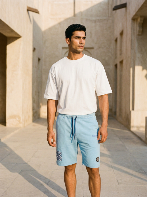 Compass Short in sky blue — ajrak patch and compass seal, limestone alley