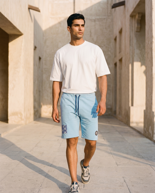 Compass Short in sky blue, walking through a golden-hour limestone alley