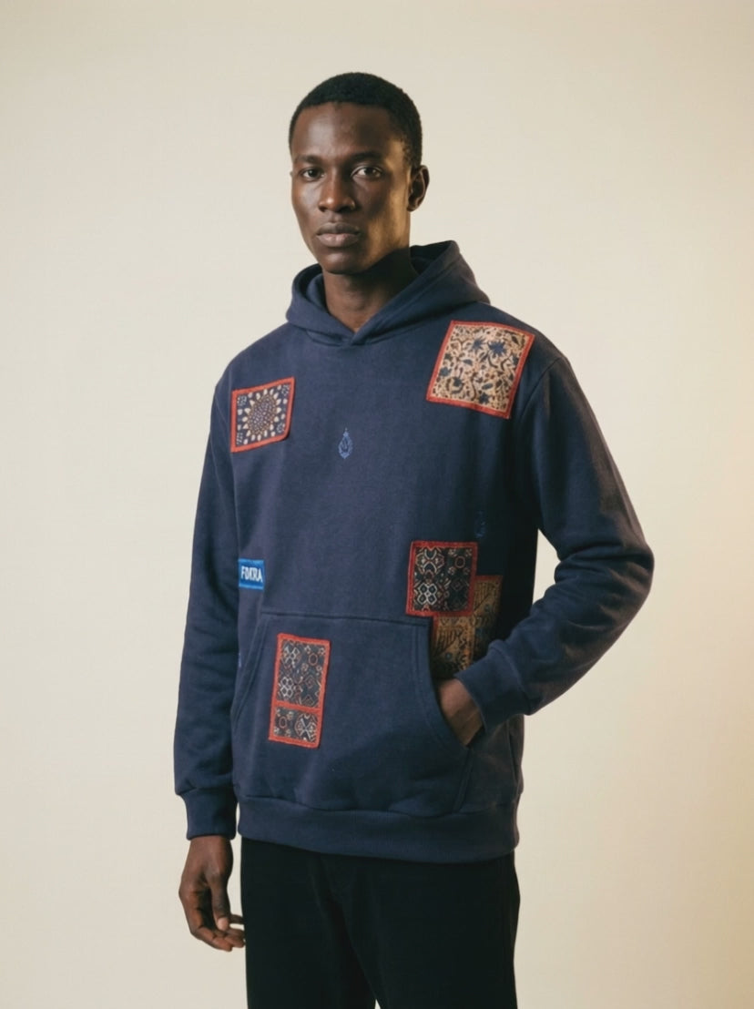 Heritage Hoodie — studio film, embroidered patches in moving light
