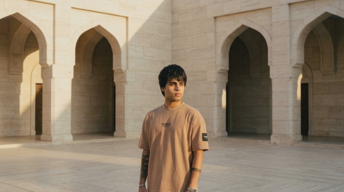 The Quiet Tee in camel — courtyard film, golden hour