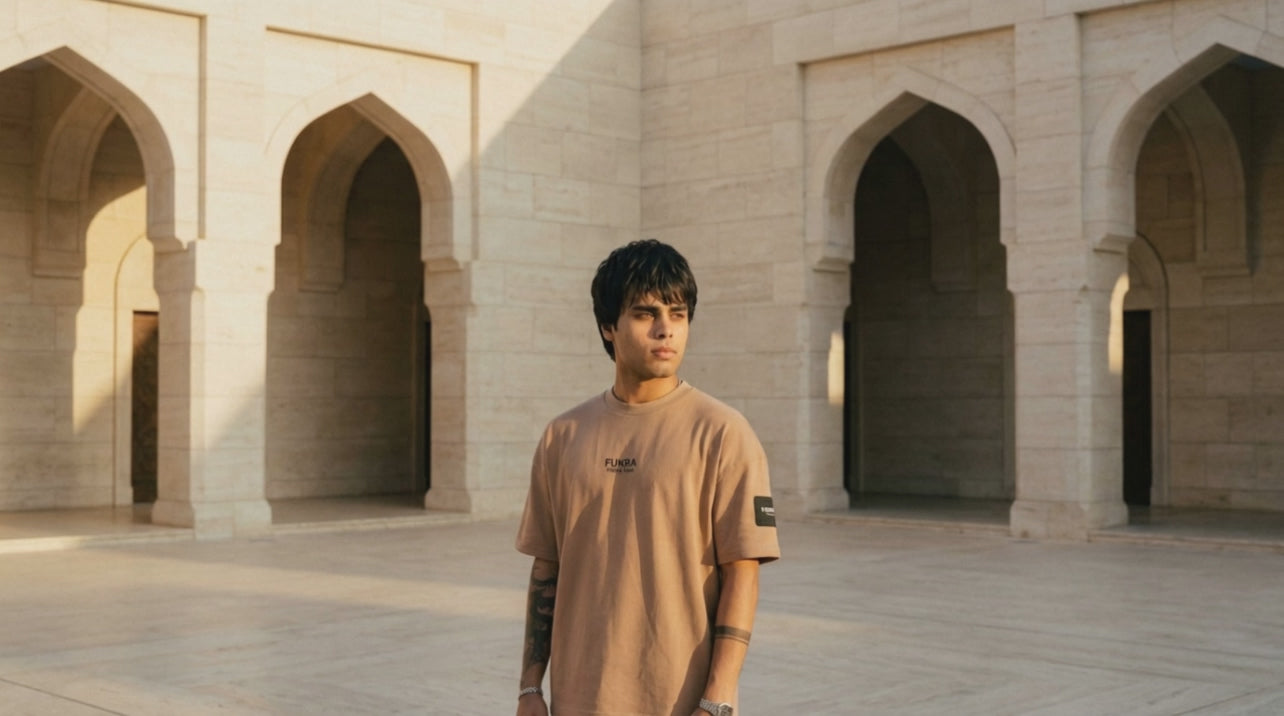 The Quiet Tee in camel — courtyard film, golden hour