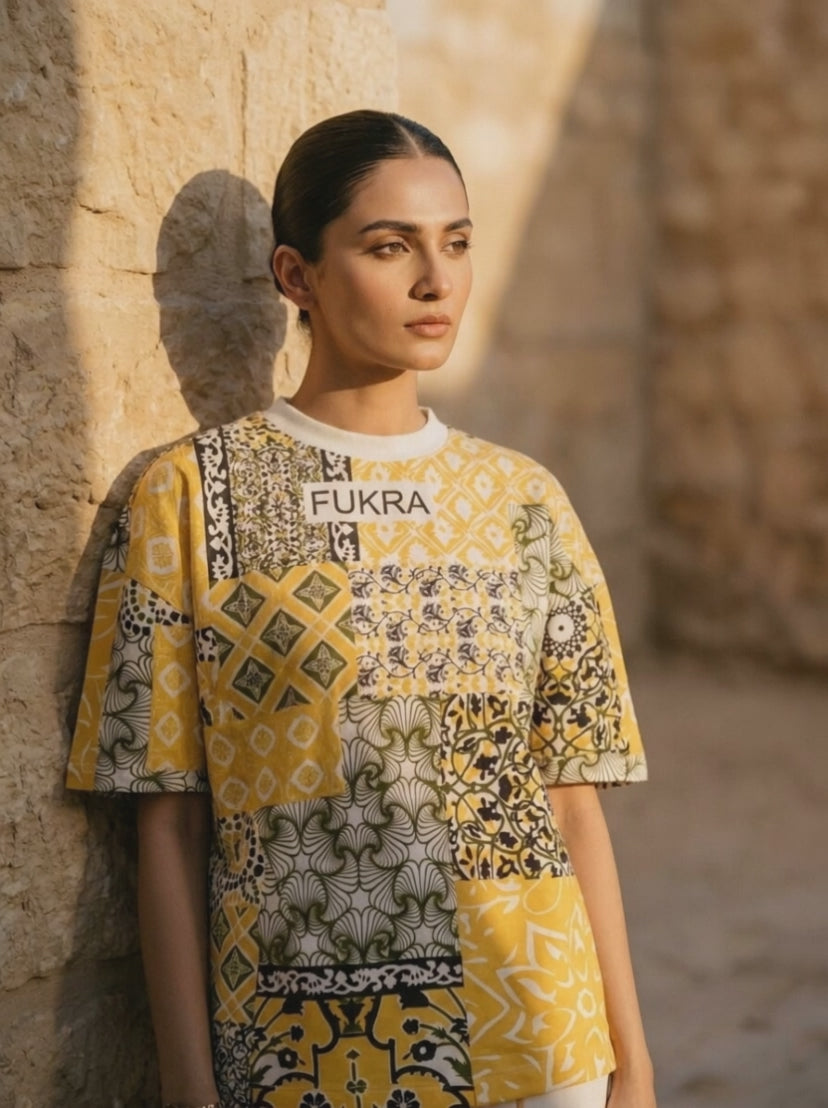 Patchwork Tee in saffron bandana — stillness film beneath sandstone arches